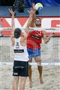 Todd Rogers (right) of USA spikes against Jonas Reckermann (GER)